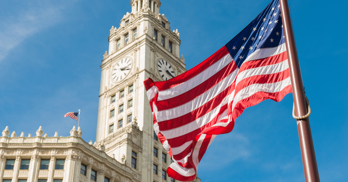 The US Flag, positioned in front of a government building