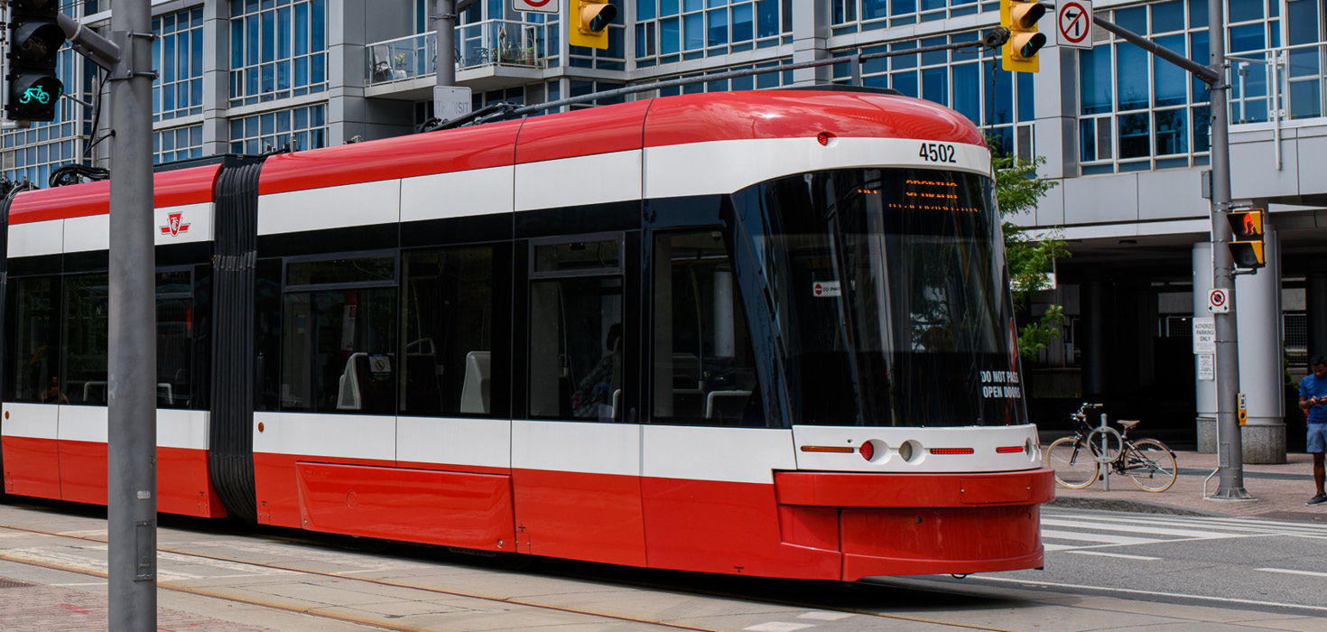 A red and white streetcar glides through Toronto.