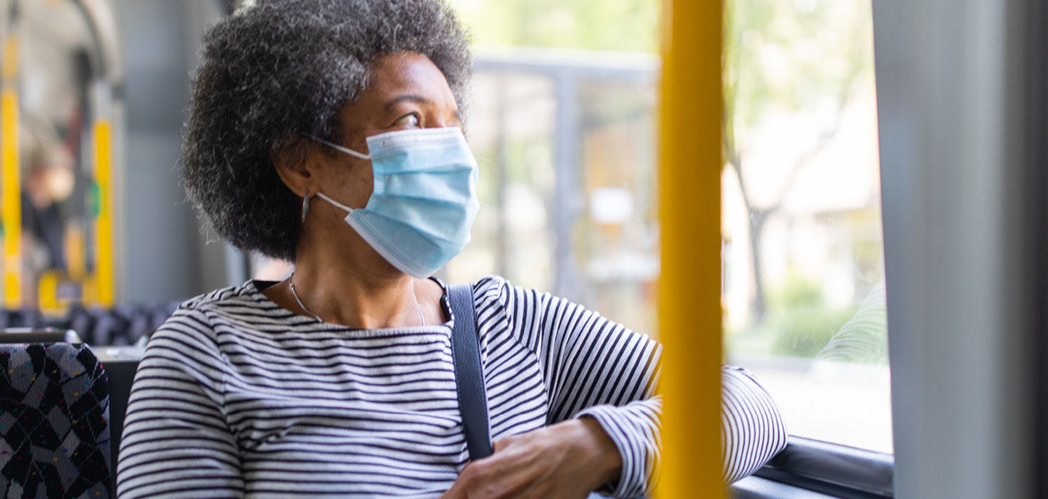 Woman in a mask in public vehicle