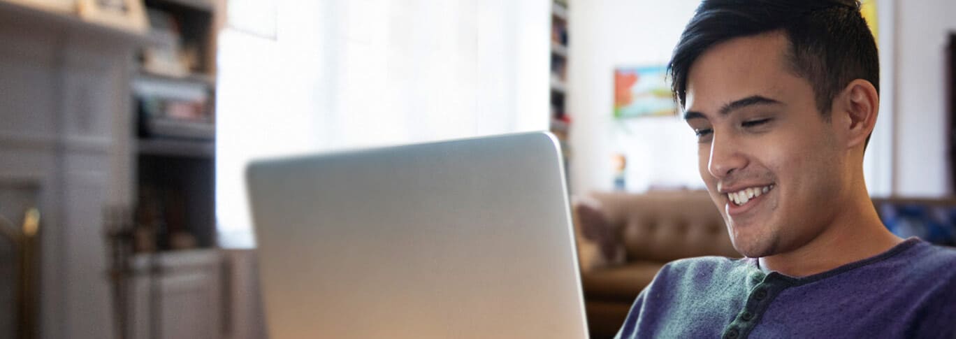 Young male on his laptop at home. 