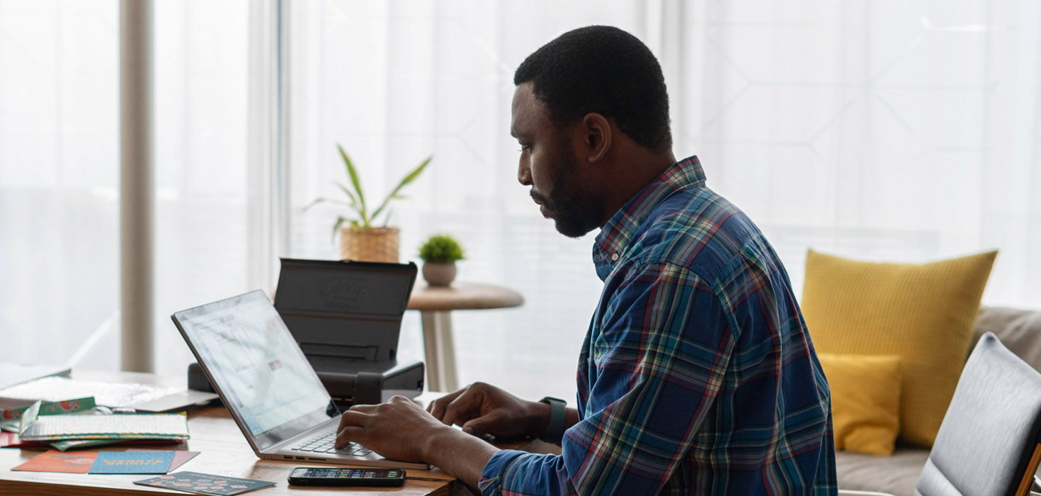 Man at computer in his home