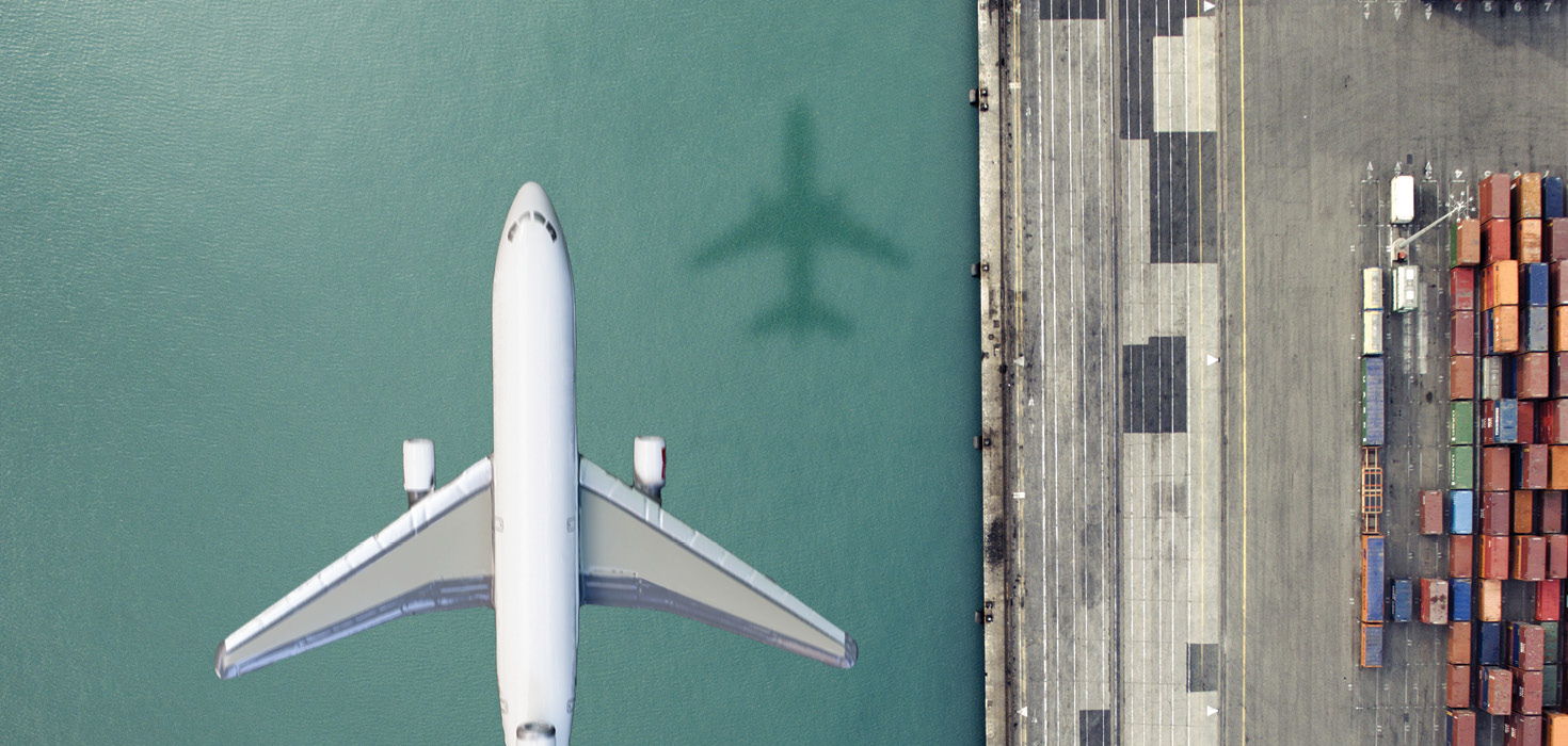 birds eye view of airplane flying over the water