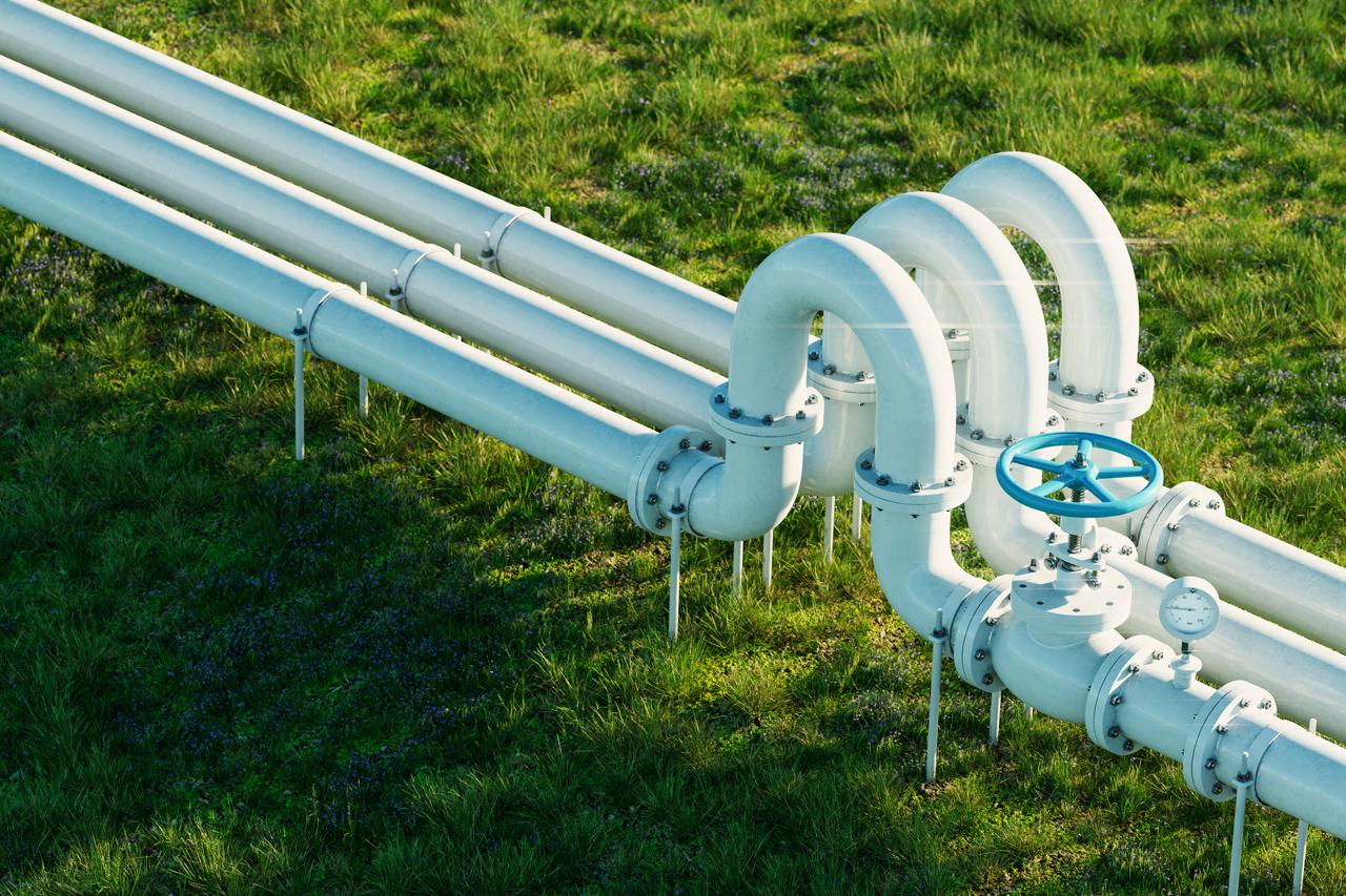 A pipeline on green grass.