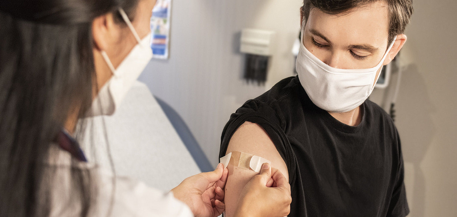 Man getting vaccinated by a healthcare professional