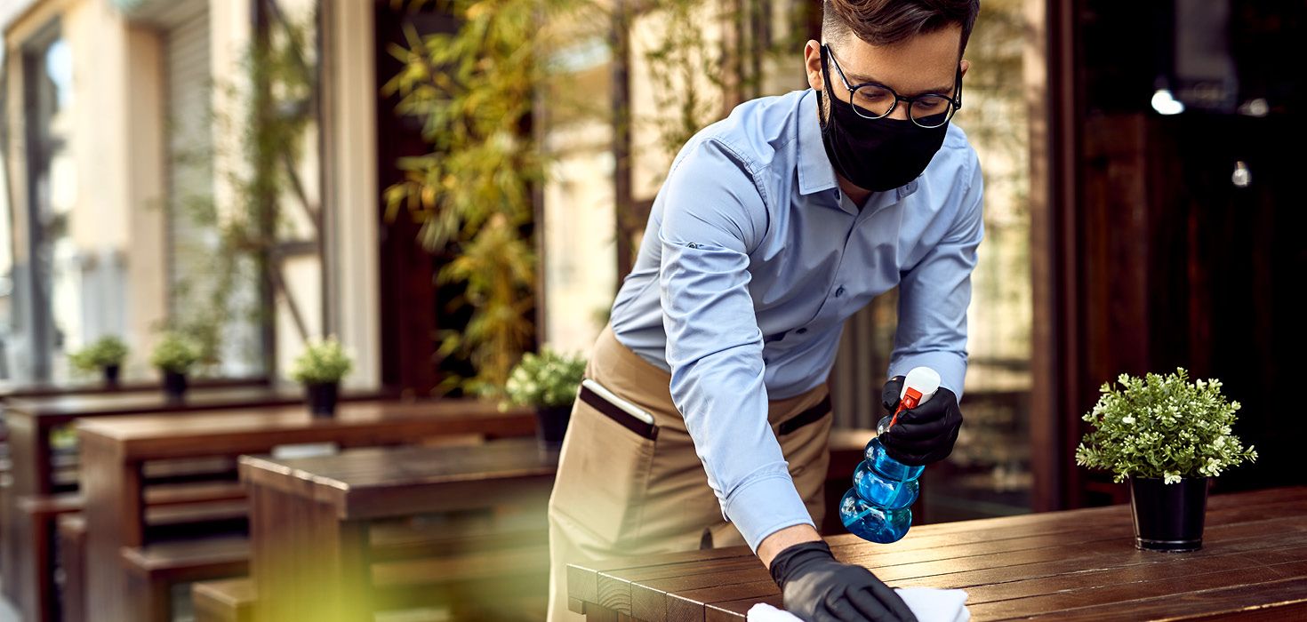 Waiter cleaning table