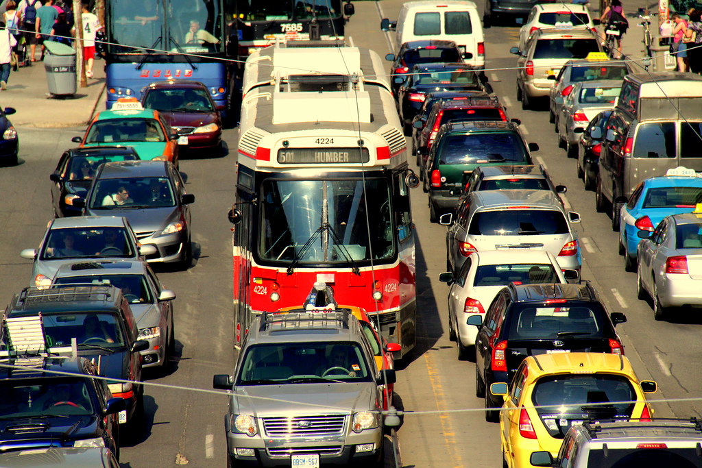 Toronto roadway filled with cars and TTC streetcar stuck in a traffic jam
