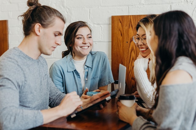 A group of 4 between 20-35 years of age socializing