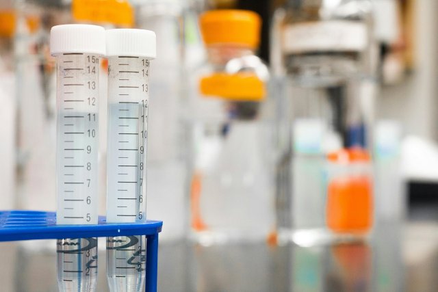 A series of test tubes in a lab environment.