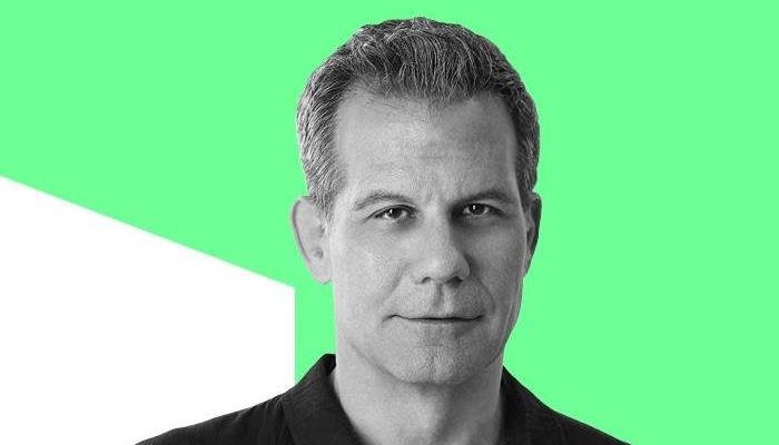 A headshot of Richard Florida, with a neon green background behind him.