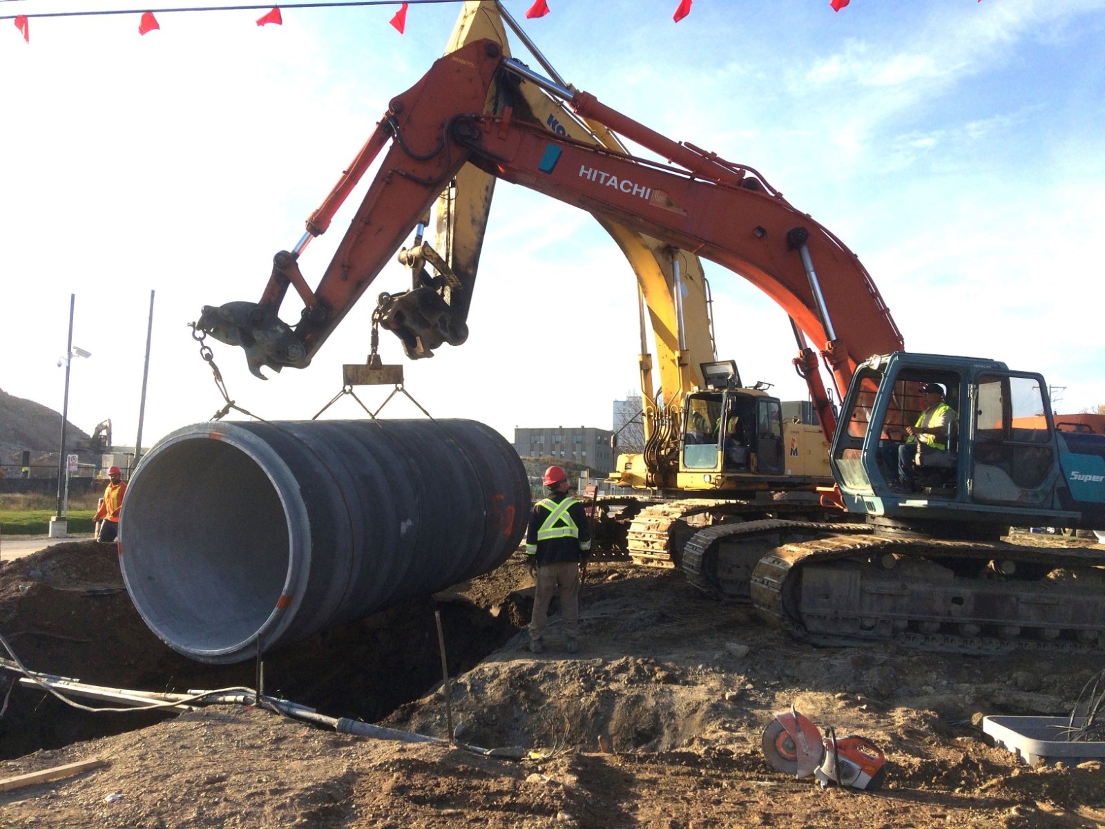 construction workers installing underground pipe