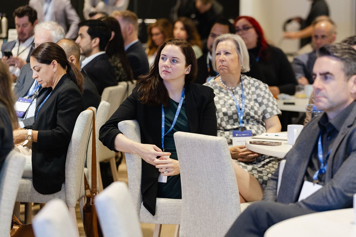 A woman listening attentively in the crowd.