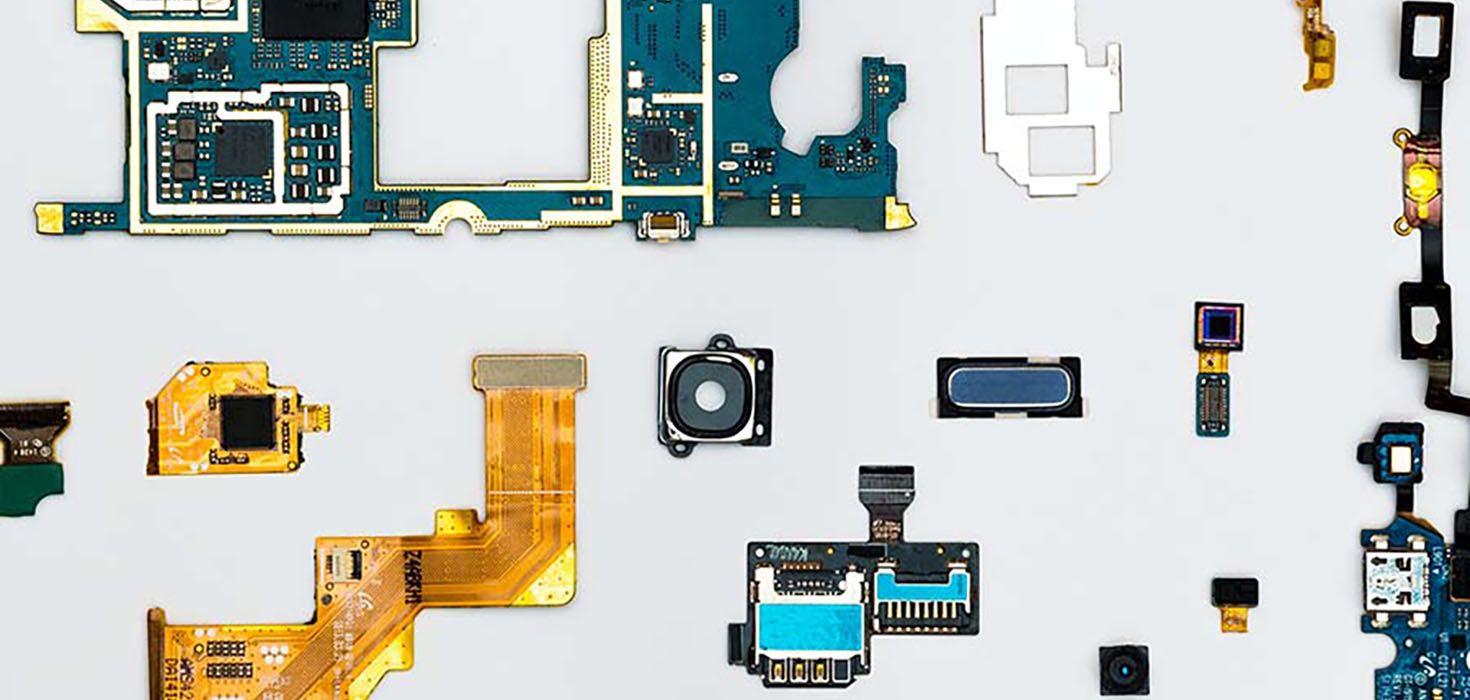 Computer chips and other technological components laid out flat on top of a white backdrop.