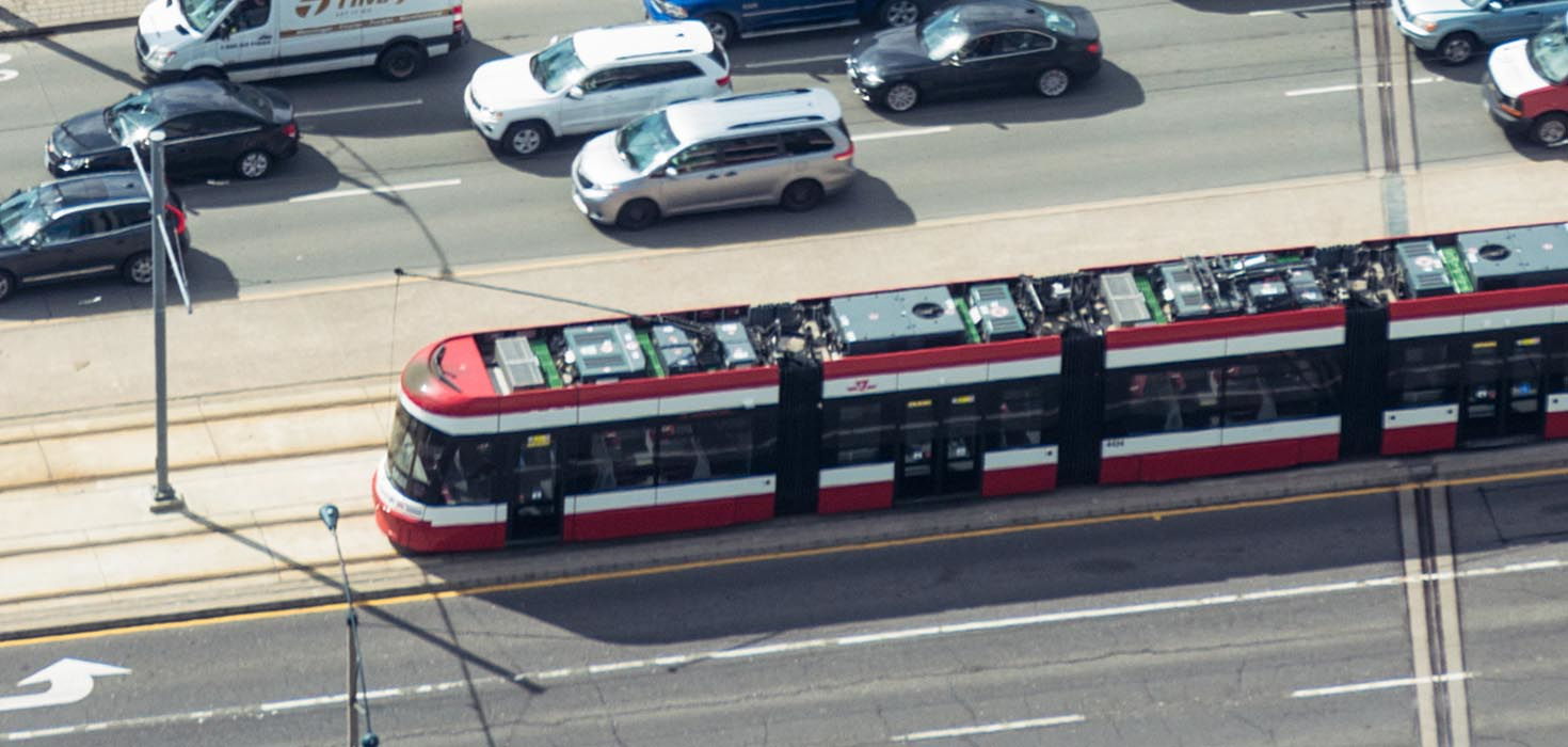 A streetcar passes several lanes of cars.
