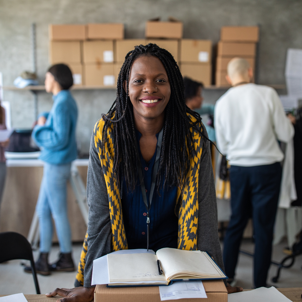 A black woman smiling confidently at the camera