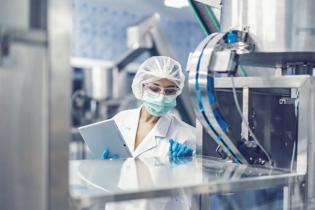 A person working in a lab on a machine.