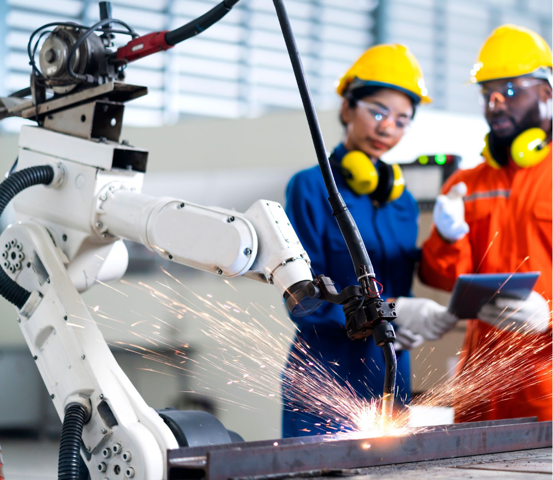 Two people supervising a cutting arm.
