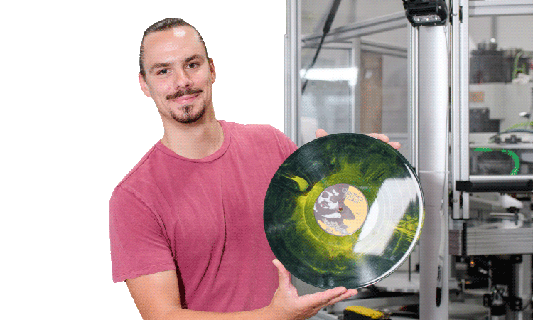 Former TAP participant and vinyl record manufacturer holding a new record.