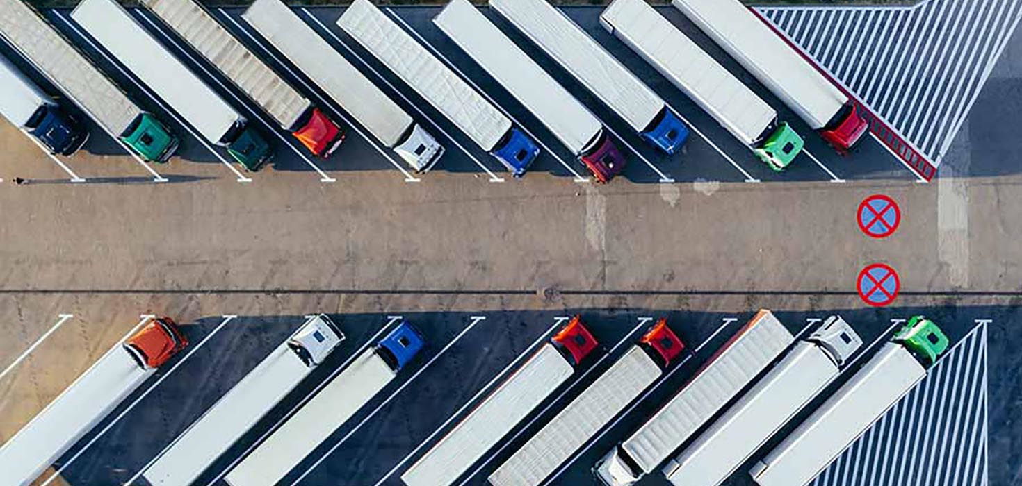 A bird’s eye view of several trucks parked in a parking lot.