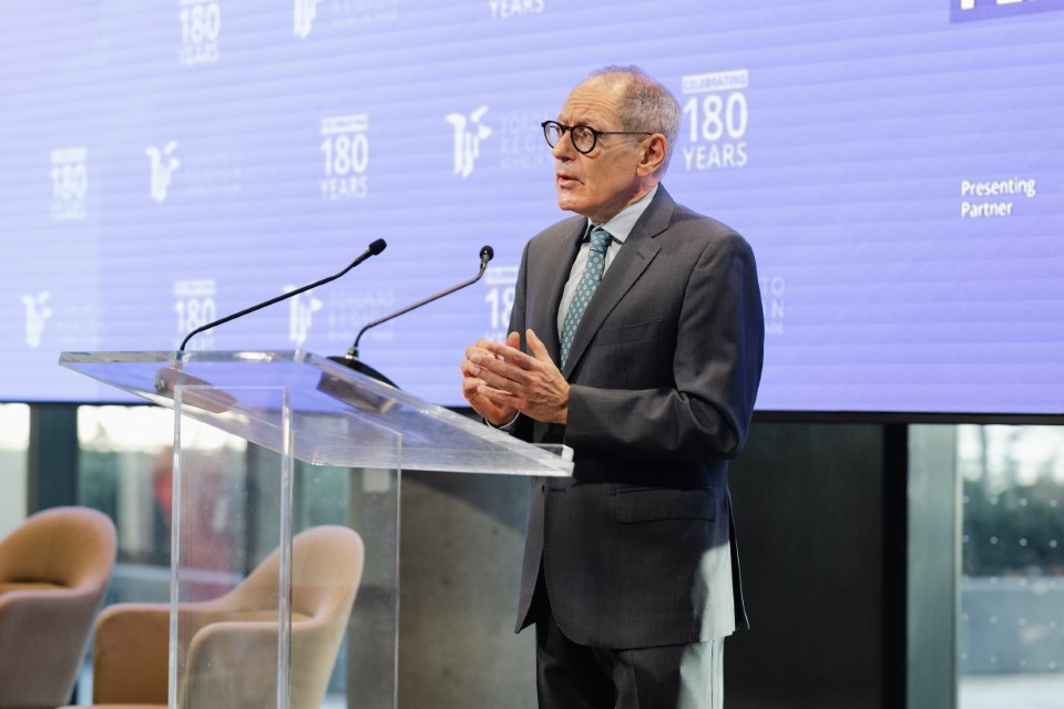 Giles Gershon speaks at a podium