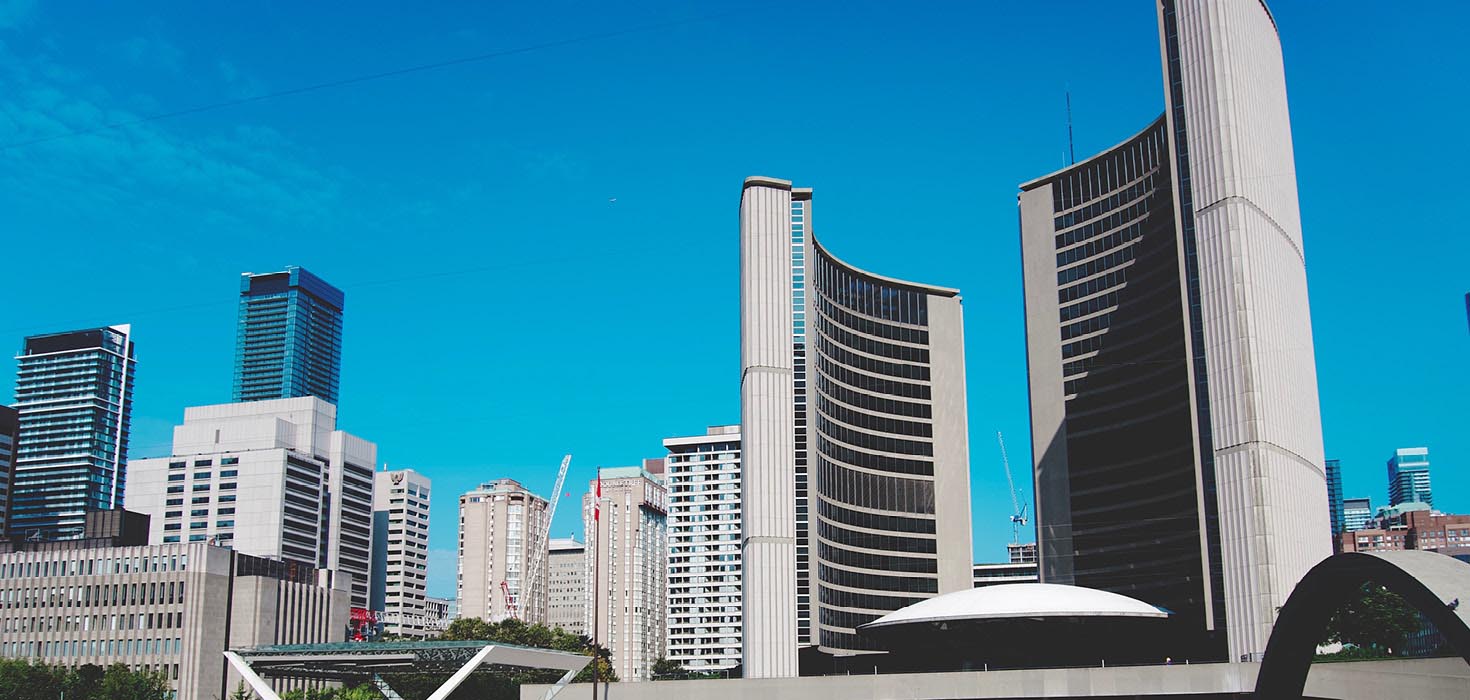 Toronto City Hall, set against a clear blue sky.