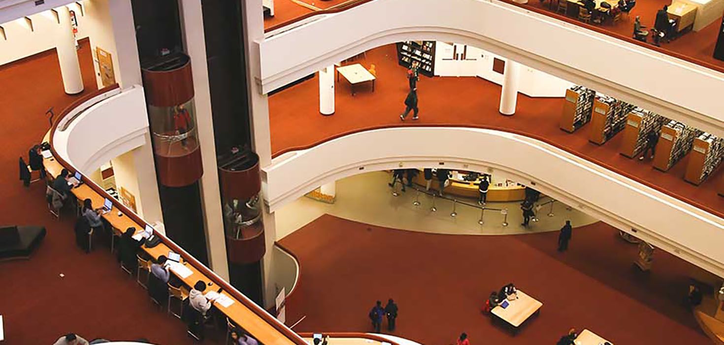 The main atrium of the Toronto Reference Library. People study and read in the atrium’s interior balconies.
