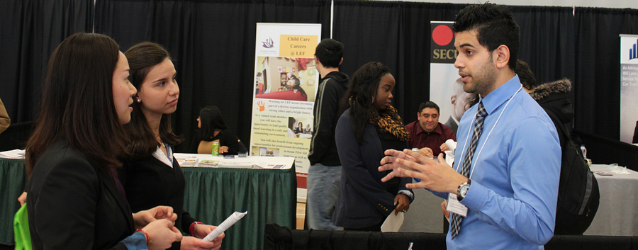 2 students talking to employment vendor