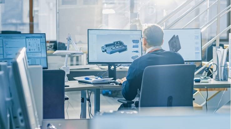 A person sitting at a computer, designing a model.