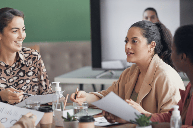 Women collaborate at a conference table
