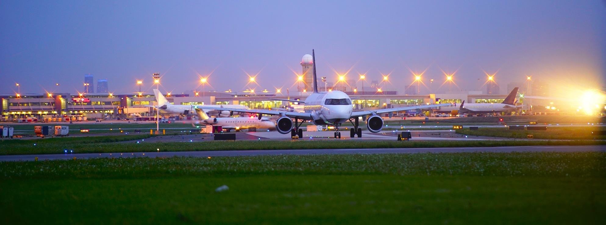 A passenger plane taxiing the runaway at night.