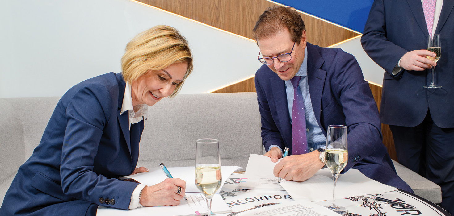 Jan De Silva, TRBOT President and Chief Executive Officer signs papers.