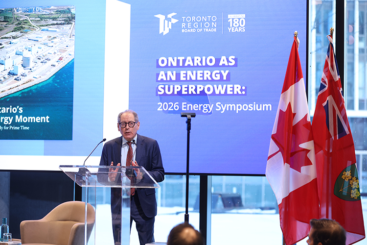 Giles Gherson speaks at a podium