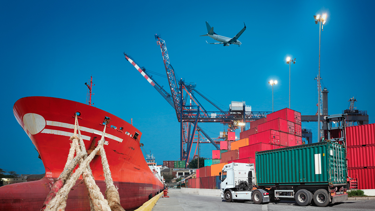 Shipyards with shipping containers, a freight truck and an airplane in the sky