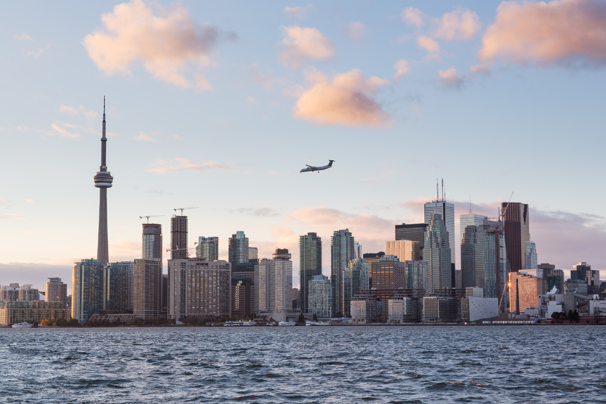 A lone airplane preparing for landing at Billy Bishop Toronto Island Airport.