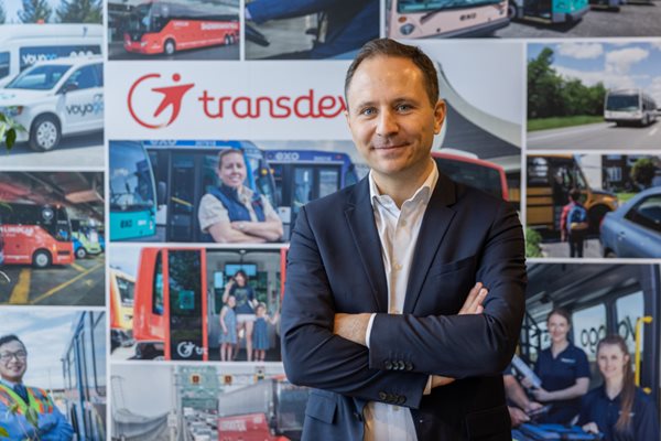 Arthur Nicolet, CEO of TransDev Canada, posed in front of a company backdrop.