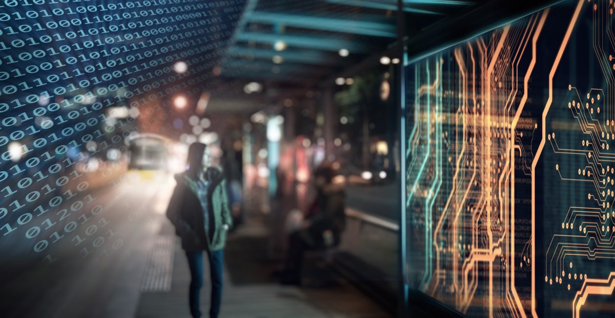 A person waiting for a train, overlaid with binary code.